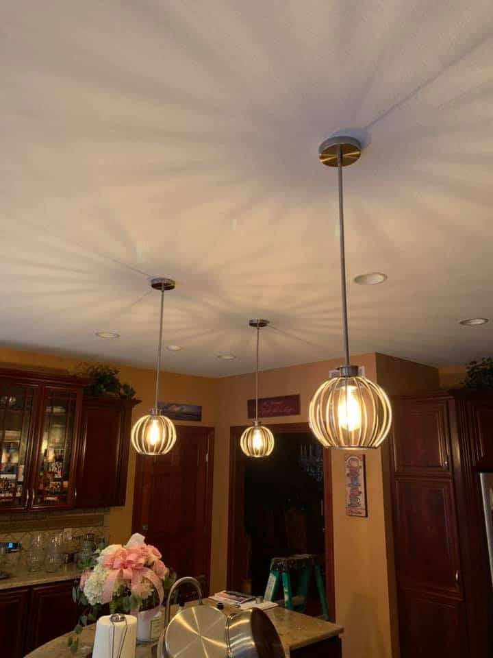 A kitchen with two pendant lights hanging over the island, installed by an electrician in Erie, PA.
