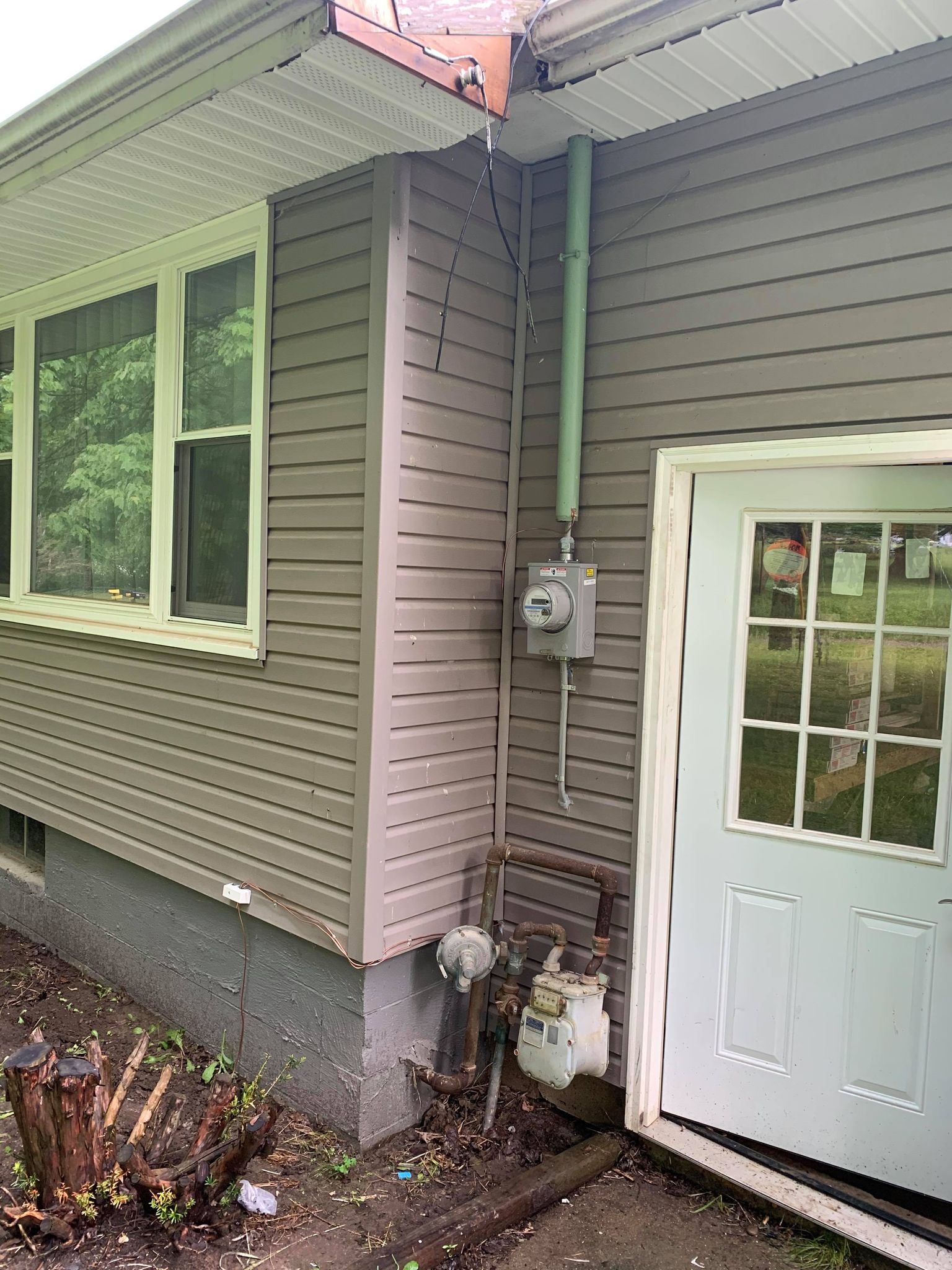A house with a white door and a gray siding, located in Erie, PA.